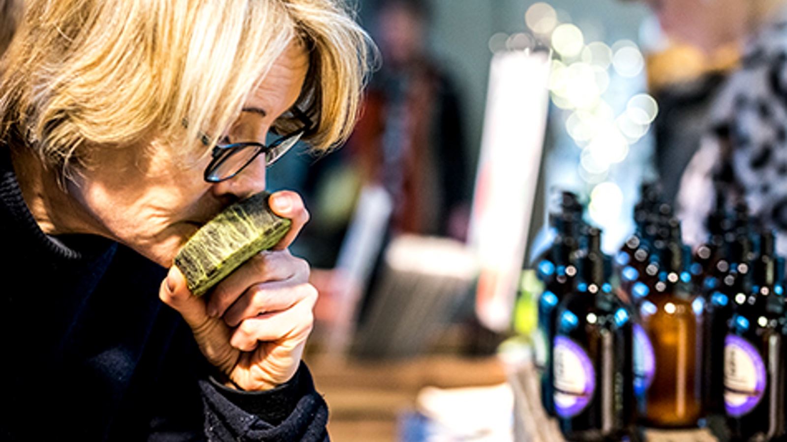 Shopper smells at product at the Made In Bristol Gift Fair